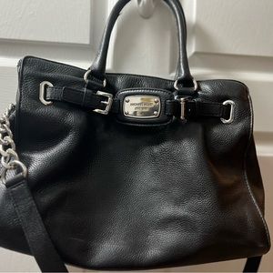 Large black leather Michael Kors bag with silver hardware.